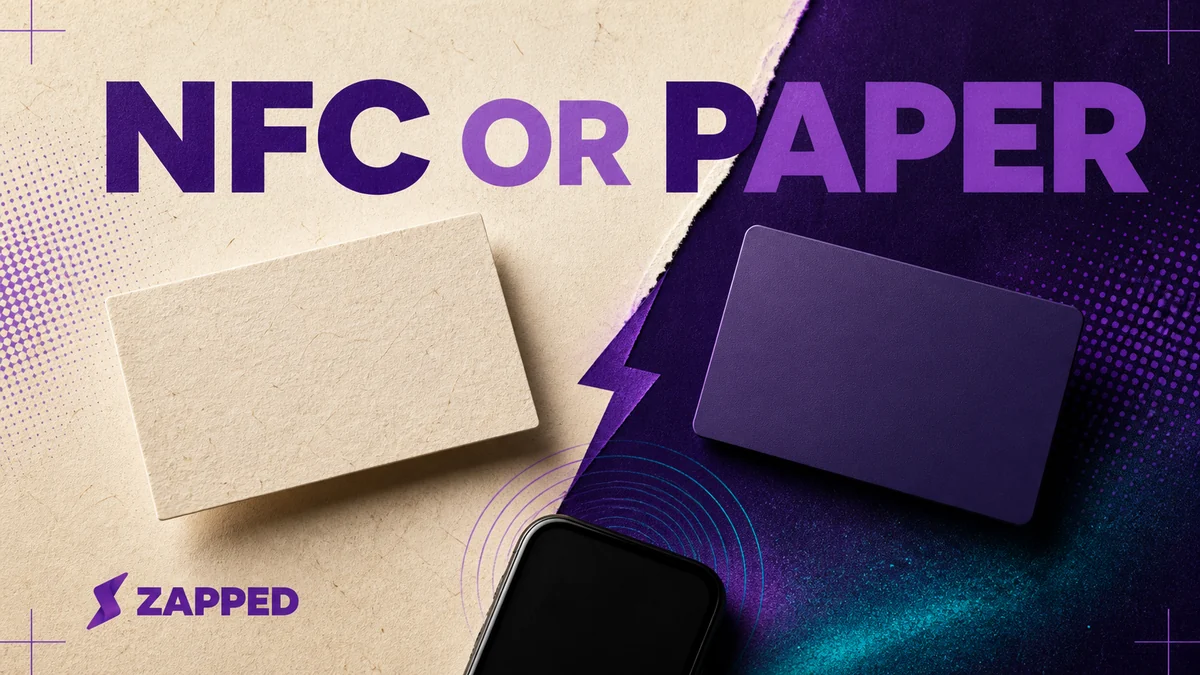 Two blank business cards, one paper and one NFC enabled, beside a phone and an abstract tap symbol