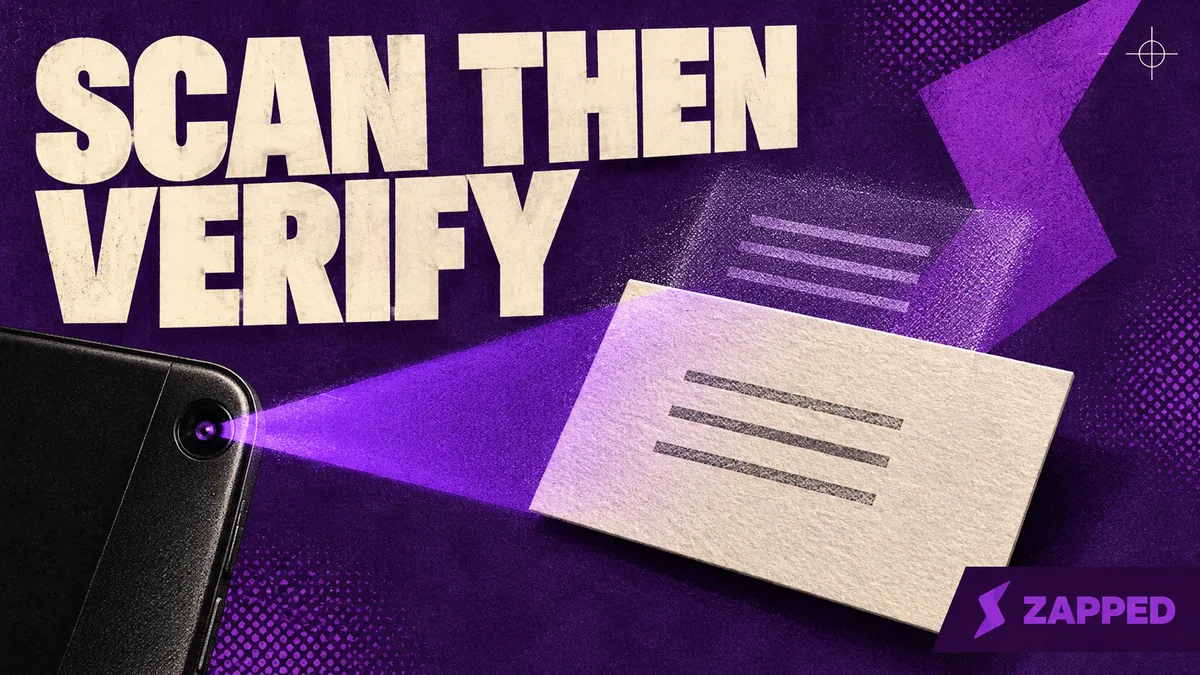 A blank paper business card beside a phone, with its printed lines left unreadable.